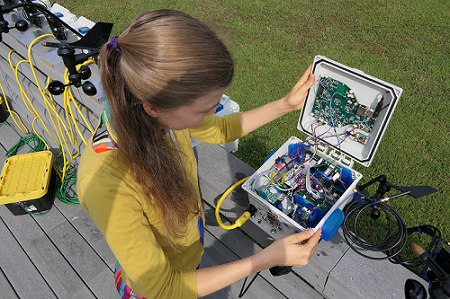 Researcher inspecting air sensor