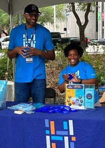 HPW employees handing out water- saving information at a local event.