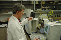 photo of chemist load ing samples on automatic sampler for volitale organic analysis (voa).