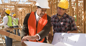 two construction workers looking at plans