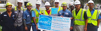 Factory workers holding an ENERGY STAR banner
