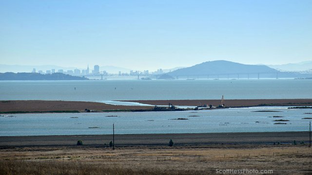 Sears Point Post Levee Breach view from a distance of the work area, now flooded wetlands, with the Richmond Bridge and San Francisco in the distance.