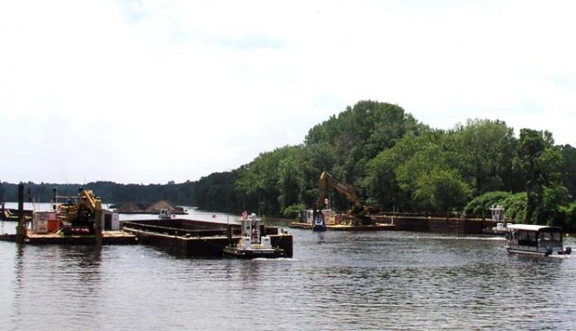 Tugboats are used to move barges of contaminated sediment to an upstream processing facility and clean backfill to the previously dredged areas.