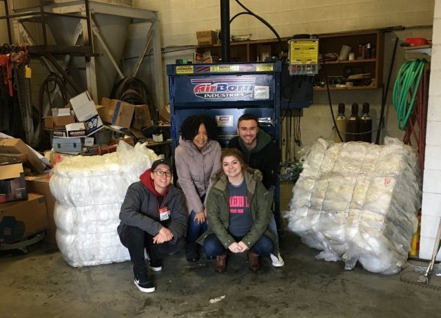 Central Michigan University Students in front of a baler