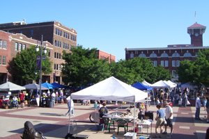 street festival in a public square surrounded by old brick buildings
