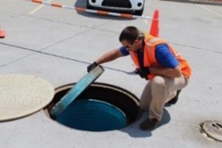 A person inspecting an underground storage tank