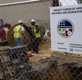 Sign on fence about American Recovery and Reinvestment Act of 2009