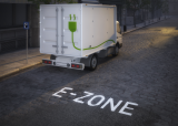 This is a decorative image of an white electric delivery van with a green plug image and the word "Ezone" on the road.