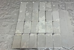 Rows of rectangular sample materials sprayed with liquid disinfectant