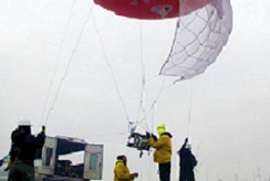 Scientists in a smoky field deploy a large balloon equipped with instruments to study wildfire smoke