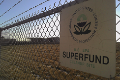 An EPA Superfund sign hangs on a chain-link fence