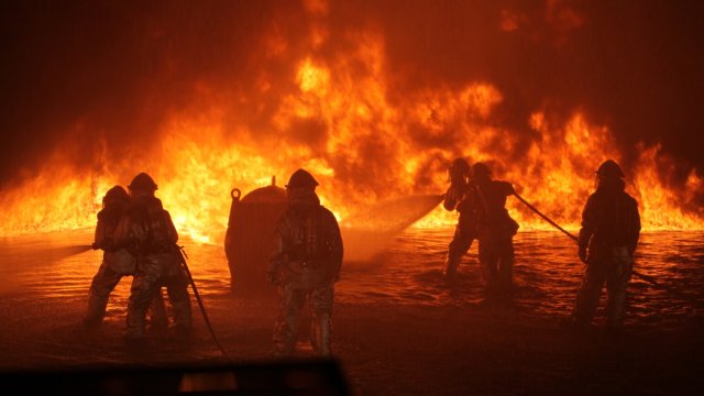 Firefighters combat an active blaze.