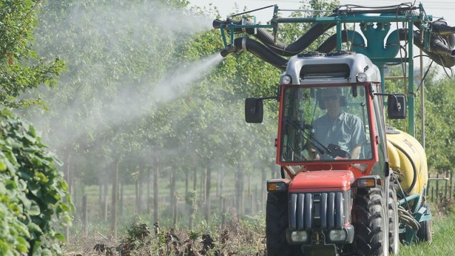 vehicle spraying crops with pesticides