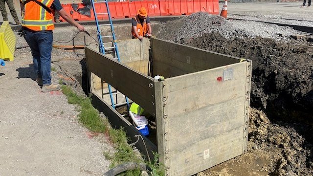 A trench box is used to prevent soil from caving in while workers are sampling in narrow areas