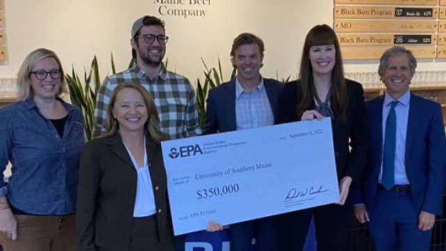 Image of people holding a large check