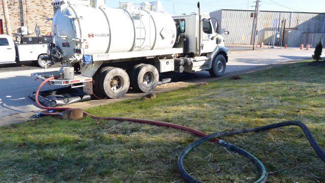 Vacuum trucks are placed next to Sulphur Run to collect any oil sheen generated during cleaning operations