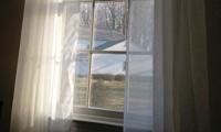 Indoor picture of a window with curtains