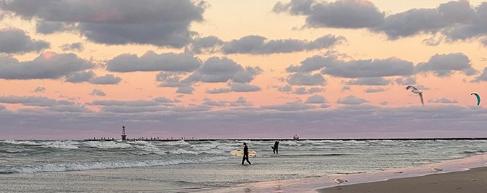 Fall sunset at Montrose beach fills the skies with pink, orange and blue color tones.