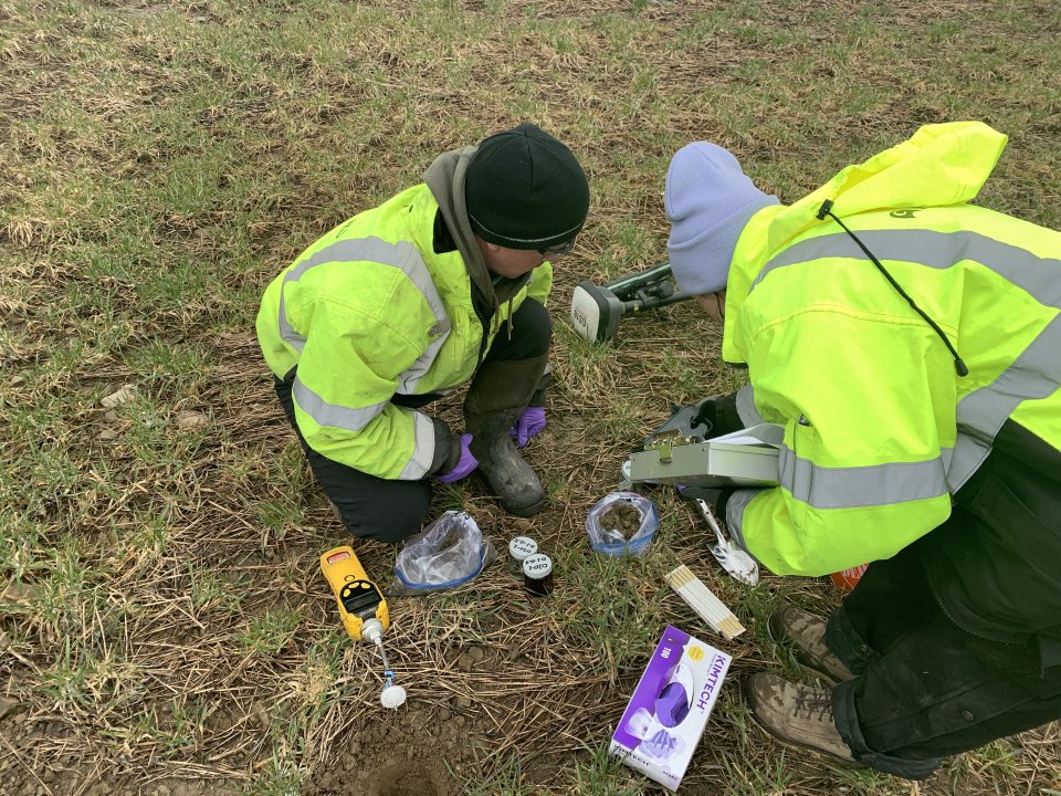 Two people taking soil samples