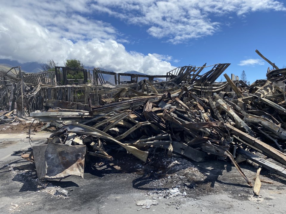 A large pile of steel and debris in Lahaina, Maui, Hawaii that highlights the difficult crews face when entering apartments to perform hazardous material removal work.