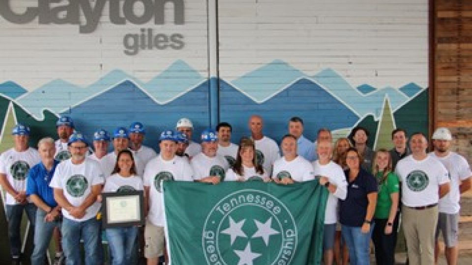 Members of the Tennessee Green Star Partnership with banner