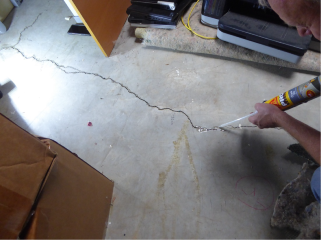 Brian Schumacher (EPA) filling a crack in the floor with epoxy