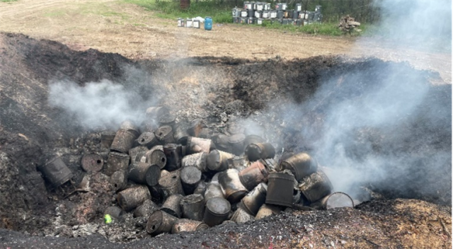 Photo of burn pit of barrels on-site