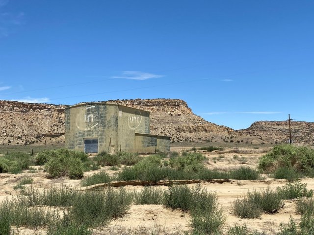 Former Ion Exchange Building facing Northwest - green industrial building in a desert landscape