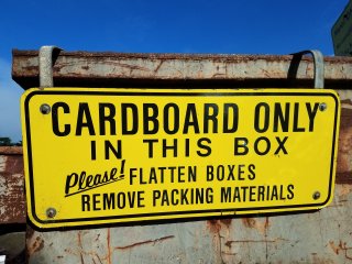 Closeup photo of Cardboard only sign.