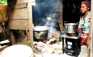 Image of a woman using a clean burning cookstove