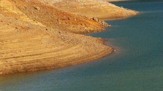 Shasta Lake at a very low level with dry bathtub rings visible.