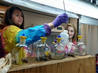 Kelly Sommers (EPA Region 3) and Troy Langknecht (ORISE participant) extract microplastics from sediment using a novel hybrid method in their laboratory.