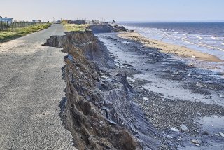 Picture of a road that has been eroded away because of wave action or sea level rise