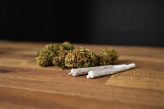 image of cannabis buds and rolled cannabis cigarettes