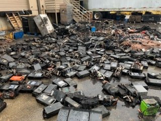 Lithium-ion battery modules and cells lie scattered after they caught fire at a universal waste battery handler in late 2021