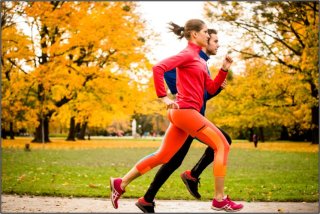 Couple jogging in park during autumn