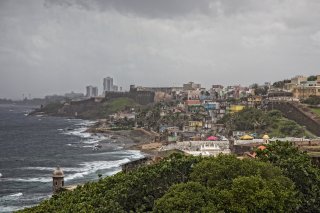 picture of a beach coastal town with stormy weather on the horizon