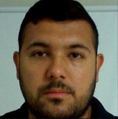 closeup headshot of hispanic male with short hair, trimmed facial hair