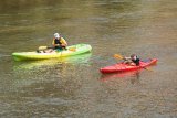 Two people in kayaks on a river