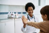 Pediatrician giving a child a high five
