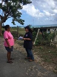 EPA field worker speaks with woman by the side of the road