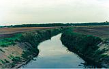 Photo of a channel cutting through agricultural fields.