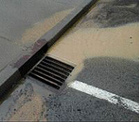 Photo showing stormwater runoff entering a storm sewer.