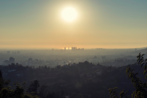 Mountain view of city with thick smog at sunset