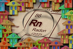 Chemical symbol of radon surrounded by mini toy houses