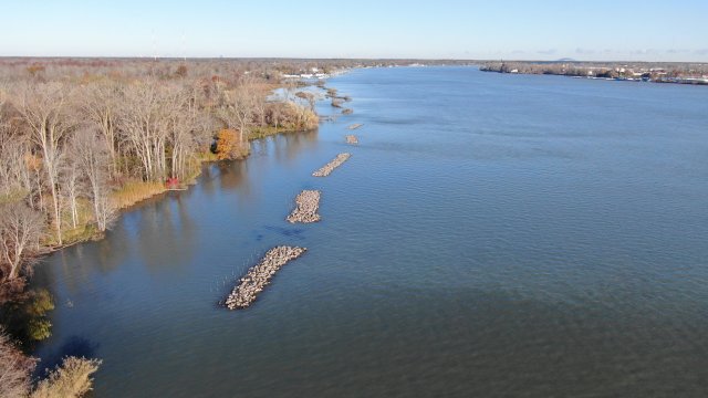Photo of An aerial view showing the constructed rock reefs protecting the shoreline. Image courtesy of NYSPRHP.