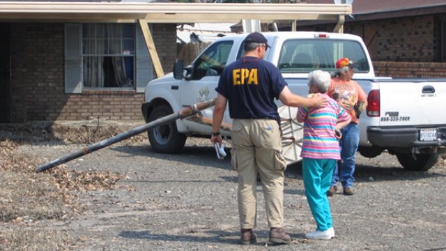 EPA employee and a woman outside of a house