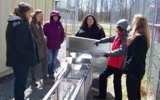 EPA and partners from the Eastern Band of Cherokee Indians review the assembly of a weather shelter for low-cost sensors.