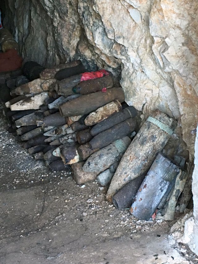 Cave interior with stacked munitions.