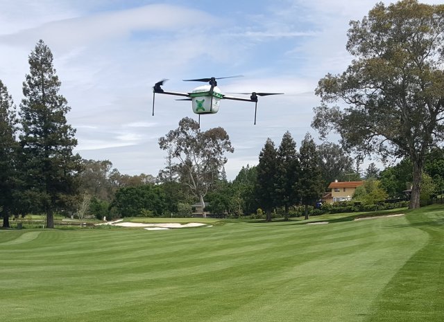 Drone flying over grass.